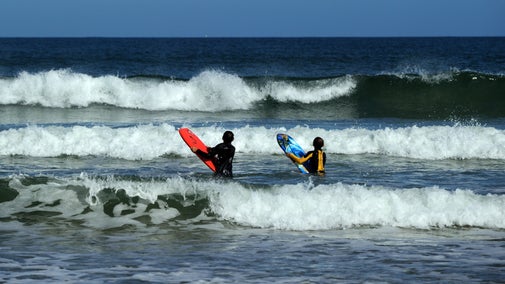 Children bodyboarding at Portstewart Strand, County Londonderry